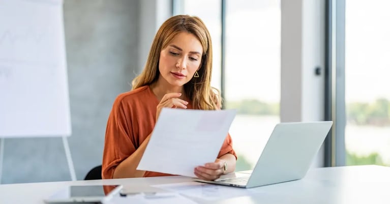 Woman looking through NALI paperwork