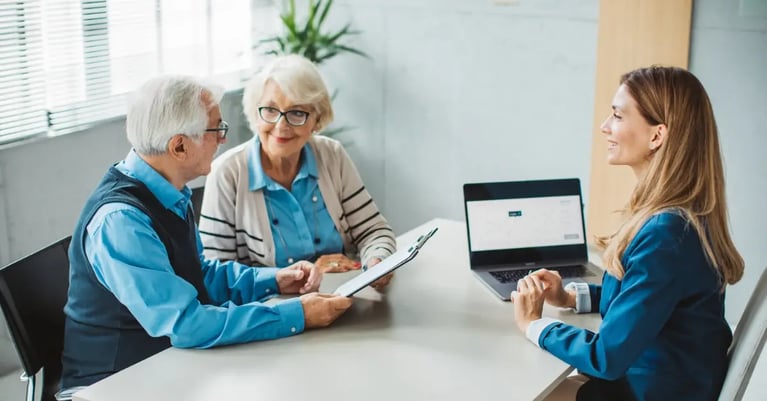 Couple learning from financial adviser